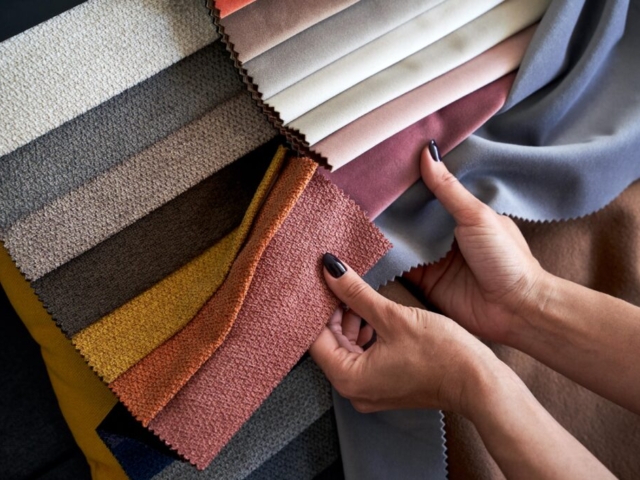 woman comparing upholstery fabric